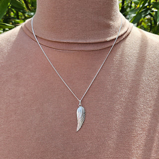 angel wing necklace being worn