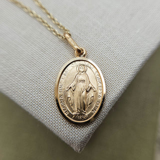 small oval miraculous medal pendant and chain