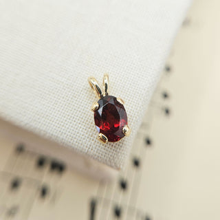dainty 9ct gold garnet charm pendant