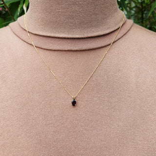 small garnet pendant on gold necklace