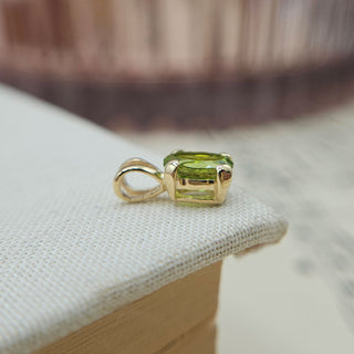 side view of olive green peridot charm