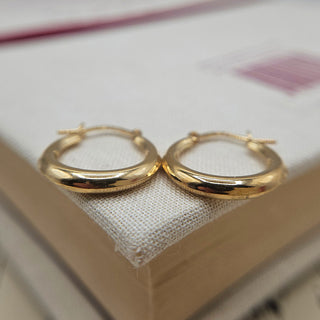 close up view of gold creole hoops