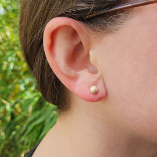 6mm gold studs in lady's ear