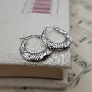 mix of polished and textured finish on silver creole hoops