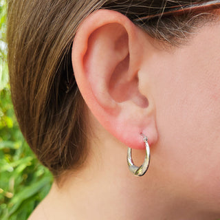 silver creole hoops in ear