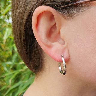 woman wearing oval creole hoops