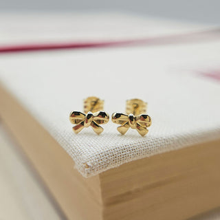 another view of bow stud earrings in 9K yellow gold