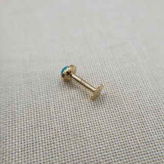 another view of solid gold labret stud set with turquoise