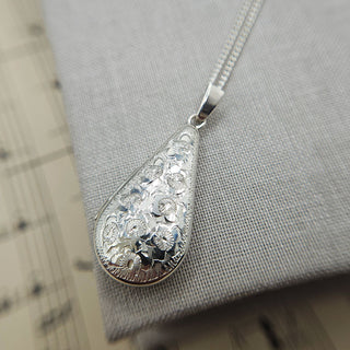 beautiful embossed and engraved floral design on silver locket