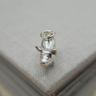 close of the pig's face on sterling silver charm