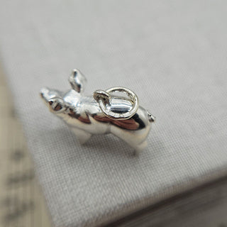 close up of silver hallmark on loop of pig charm