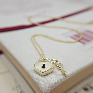 close up of padlock and key pendant in 9ct gold