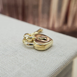 close up of padlock and key pendant in 9ct gold