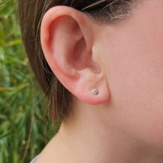 woman wearing March birthstone studs