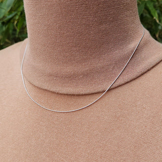 dainty white gold snake chain being worn