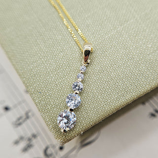 graduated cubic zirconia pendant and chain in gold