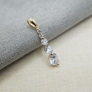 close up of gold and cz drop pendant