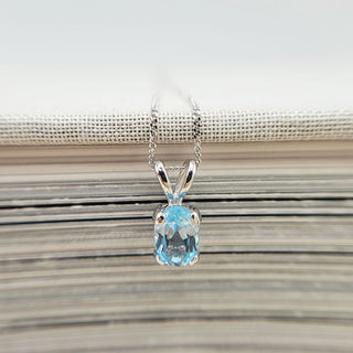 dainty oval blue topaz pendant in white gold