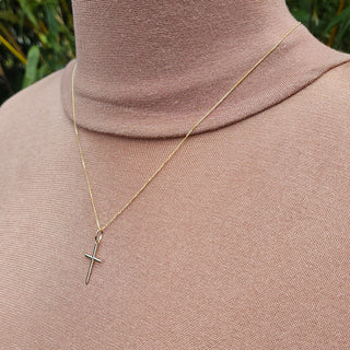 another view of skinny gold cross necklace being worn