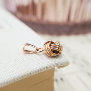 side profile of pink gold knot pendant