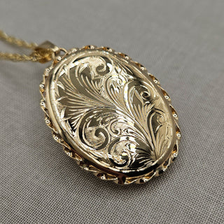 close up of hand engraved floral spray design on locket