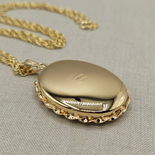 polished reverse of locket with hallmark