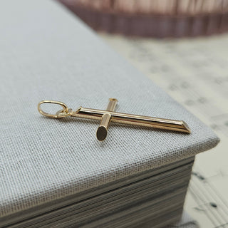 side profile of rounded tube cross pendant in gold