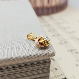 side profile of 2 tone gold knot pendant