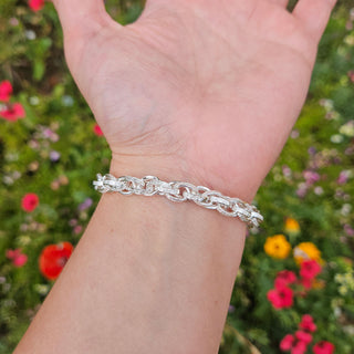 another view of silver charm bracelet on woman's wrist