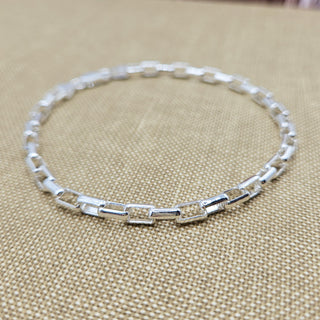 close up of rectangular links on silver chain bracelet