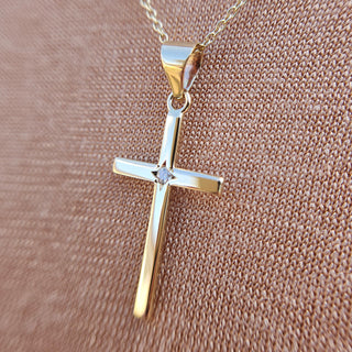 real 9ct gold cross set with a natural diamond