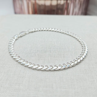 close up of silver cuban curb chain bracelet