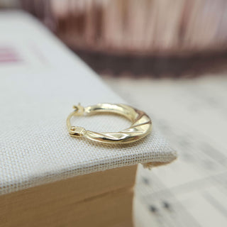 side profile of small gold hoops