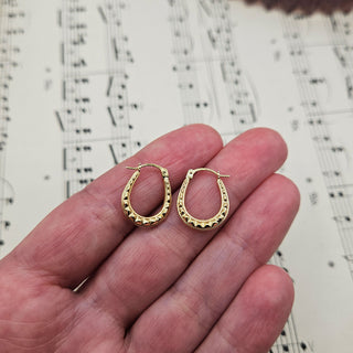 9ct gold creole earrings in hand for scale