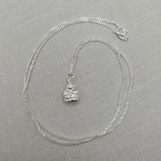 Silver Buddha pendant on curb chain