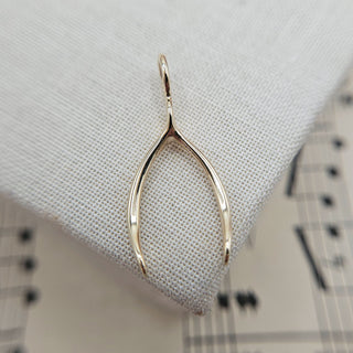 hallmarked wishbone charm in 9K gold