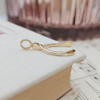 side profile of hallmarked wishbone pendant