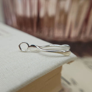 side profile of hallmarked silver wishbone charm