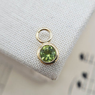 small peridot charm in 9ct gold