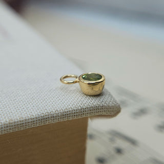 bezel set peridot charm in gold