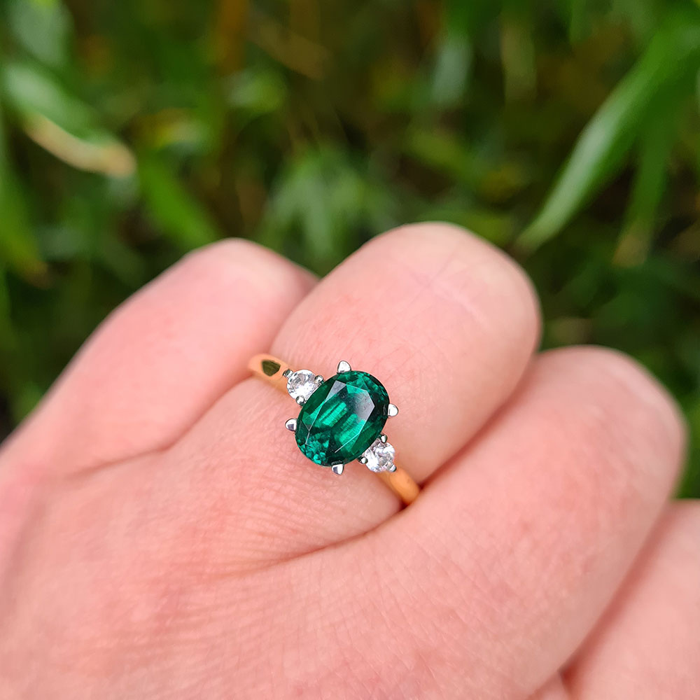 emerald engagement ring on hand