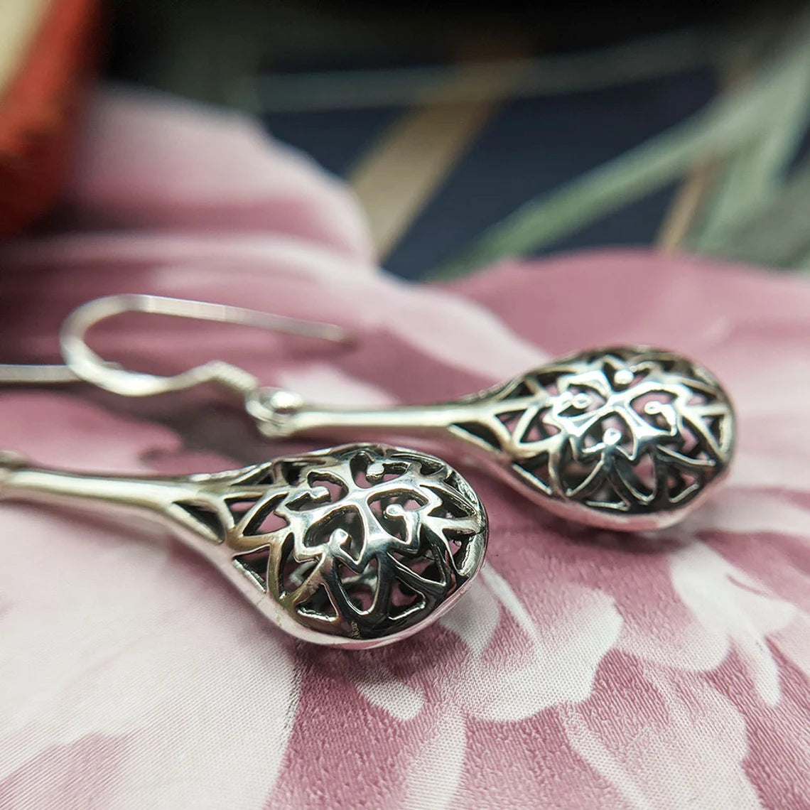 close up of vintage style silver dangle earrings