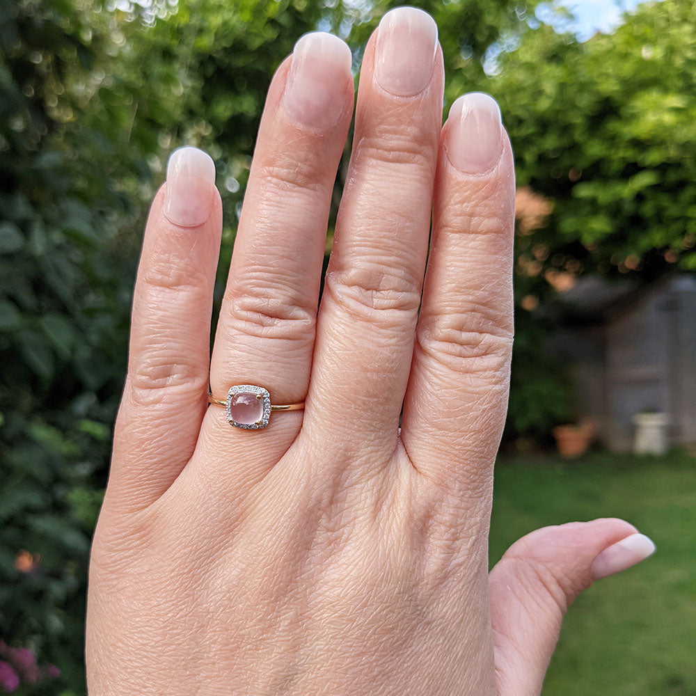 rose quartz ring on hand
