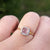 rose quartz ring on finger