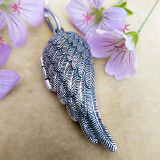 close up of angel wing locket