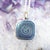 close up of silver zodiac pendant