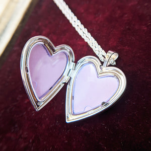 heart locket open with two spaces for photos