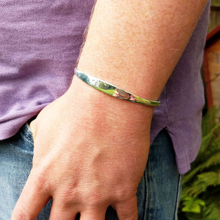 solid silver cuff bangle on man's wrist