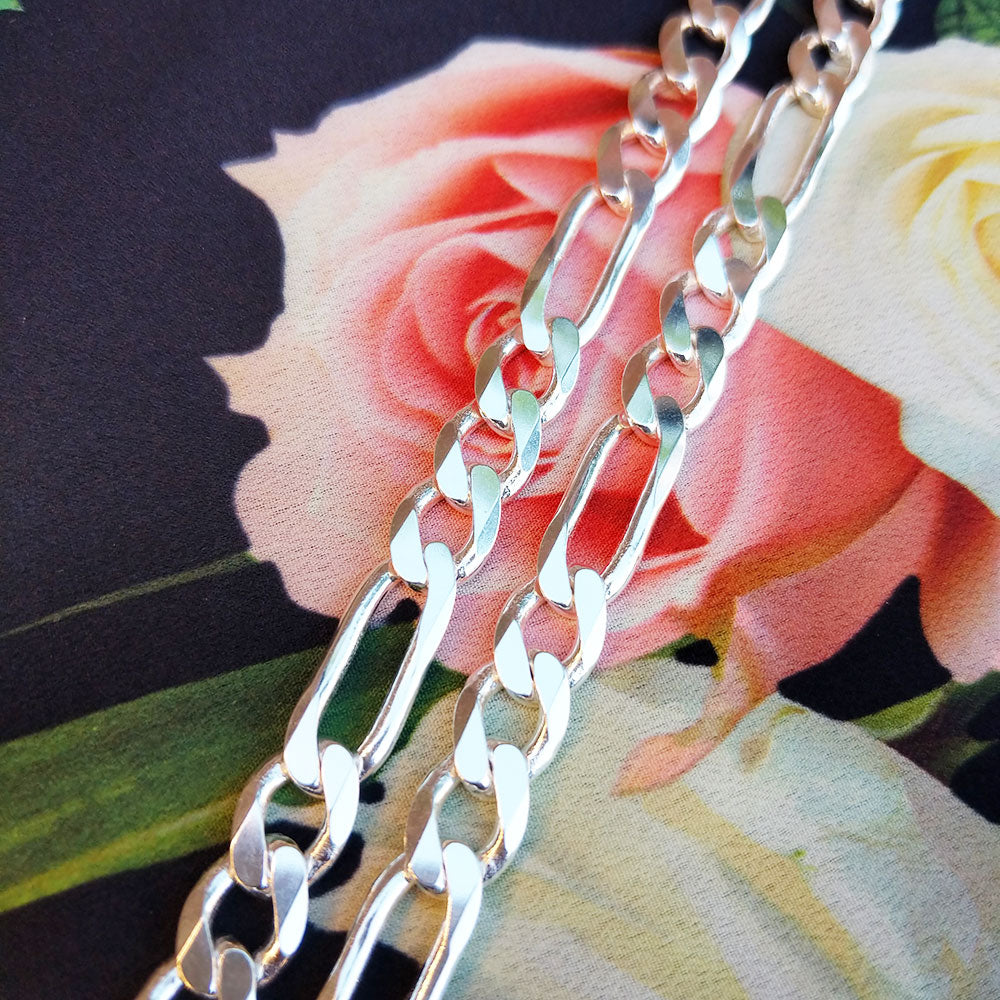 close up of silver figaro chain