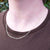 fine gold figaro chain on man's neck